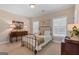 Inviting bedroom featuring an iron bed frame, shuttered windows, and a dresser at 127 Darwish Dr, Mcdonough, GA 30252