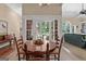 Cozy dining room offers views of the outdoor landscape and a peek into the inviting living area at 127 Darwish Dr, Mcdonough, GA 30252