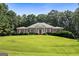 Charming brick home featuring a manicured lawn, well-kept landscaping, and classic architectural details at 127 Darwish Dr, Mcdonough, GA 30252