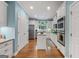 Bright kitchen with stainless steel appliances, an island, and hardwood floors offers a modern design at 127 Darwish Dr, Mcdonough, GA 30252