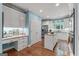 Well-lit kitchen boasts an island, stainless steel appliances, and adjacent desk area for added convenience at 127 Darwish Dr, Mcdonough, GA 30252