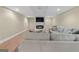 Cozy living room boasts a fireplace with TV, recessed lighting, and comfortable neutral-toned furniture at 127 Darwish Dr, Mcdonough, GA 30252