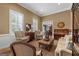 Elegant living room featuring classic furnishings, natural light, and a view of the dining area at 127 Darwish Dr, Mcdonough, GA 30252