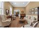 Comfortable living room with neutral tones, plush seating, and an open view into the dining area at 127 Darwish Dr, Mcdonough, GA 30252