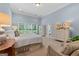 Bright main bedroom with large windows and an ensuite bathroom entrance at 127 Darwish Dr, Mcdonough, GA 30252