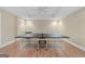 Finished basement space features a ping pong table, brick accent wall and recessed lighting at 127 Darwish Dr, Mcdonough, GA 30252