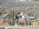 Aerial view of a 1.27-acre lot featuring a home and storage building surrounded by dense trees at 175 Laney Ct, Mcdonough, GA 30252