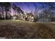 Spacious backyard featuring a well-maintained lawn, a large storage building, and mature trees providing ample privacy at 175 Laney Ct, Mcdonough, GA 30252