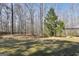 Spacious backyard featuring mature trees and a covered outdoor seating area at 175 Laney Ct, Mcdonough, GA 30252