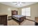 Traditional bedroom features a wooden bed frame and a ceiling fan, offering a comfortable space at 175 Laney Ct, Mcdonough, GA 30252