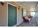 Charming front porch featuring seating and a green front door, creating a cozy entrance to the home at 175 Laney Ct, Mcdonough, GA 30252