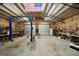 Well-lit garage offering ample space for a workshop with a lift, and storage, illuminated by bright overhead lights at 175 Laney Ct, Mcdonough, GA 30252