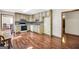 Kitchen featuring white appliances and wood cabinets adjacent to a dining area at 175 Laney Ct, Mcdonough, GA 30252