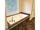 This bathroom features a jacuzzi tub, and tile accents at 1008 Stonekirk Trce, Lawrenceville, GA 30043