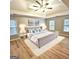 This bedroom features carpet, a ceiling fan, and many windows for natural light at 1008 Stonekirk Trce, Lawrenceville, GA 30043