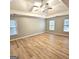 This bedroom features carpet, a ceiling fan, and many windows for natural light at 1008 Stonekirk Trce, Lawrenceville, GA 30043