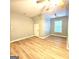 Bright and airy bedroom featuring a ceiling fan, a window and wood-look flooring at 1008 Stonekirk Trce, Lawrenceville, GA 30043