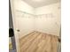 This walk-in closet features wood flooring and wire shelves for optimal storage at 1008 Stonekirk Trce, Lawrenceville, GA 30043