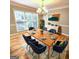 The bright dining room is fully furnished and features a modern chandelier at 1008 Stonekirk Trce, Lawrenceville, GA 30043