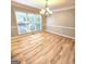 Large dining room featuring a decorative chandelier with lots of natural light at 1008 Stonekirk Trce, Lawrenceville, GA 30043
