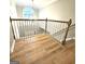 This foyer features hardwood floors, a bright window, and wooden banisters at 1008 Stonekirk Trce, Lawrenceville, GA 30043