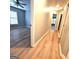 Bright hallway with light wood flooring leading to a bedroom with a window at 1008 Stonekirk Trce, Lawrenceville, GA 30043