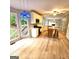 Bright kitchen features an island, light-colored cabinets, stainless steel appliances, and adjacent sunroom at 1008 Stonekirk Trce, Lawrenceville, GA 30043