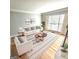 Bright living room features a large window, wood floors, and a comfortable seating arrangement at 1008 Stonekirk Trce, Lawrenceville, GA 30043