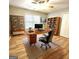 Home office with a large desk, modern shelving, and a comfortable executive chair at 1008 Stonekirk Trce, Lawrenceville, GA 30043