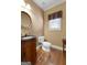 Charming powder room with ornate vanity, black granite countertop, and decorative mirror at 340 Antebellum Way, Fayetteville, GA 30215