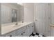 Well-lit bathroom featuring a vanity with white cabinets and a black and white tile floor at 340 Antebellum Way, Fayetteville, GA 30215