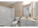 Bright bathroom featuring a tub/shower combo, toilet, and vanity with white cabinets at 340 Antebellum Way, Fayetteville, GA 30215