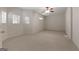 Neutral bedroom with carpet flooring, ceiling fan, and natural light from multiple windows at 340 Antebellum Way, Fayetteville, GA 30215