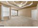 Spacious bedroom features a trey ceiling, plush carpet, and many windows providing abundant natural light at 340 Antebellum Way, Fayetteville, GA 30215