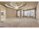 Spacious bedroom features a trey ceiling, plush carpet, and many windows providing abundant natural light at 340 Antebellum Way, Fayetteville, GA 30215