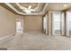 Spacious bedroom features a trey ceiling, plush carpet, and many windows providing abundant natural light at 340 Antebellum Way, Fayetteville, GA 30215