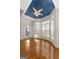 Bright breakfast nook with bay windows, hardwood floors, blue tray ceiling and stylish ceiling fan at 340 Antebellum Way, Fayetteville, GA 30215