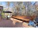 A spacious wooden deck with outdoor furniture, a built-in bench, and a grill, perfect for entertaining at 340 Antebellum Way, Fayetteville, GA 30215