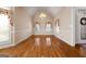 Bright dining room with vaulted ceiling, chandelier, hardwood floors, and large windows with custom floral-patterned drapery at 340 Antebellum Way, Fayetteville, GA 30215