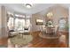 Cozy dining room features hardwood flooring, dining table with seating, and an additional seating area with accent chairs at 340 Antebellum Way, Fayetteville, GA 30215