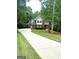 Charming two-story brick home featuring a long driveway and lush landscaping at 340 Antebellum Way, Fayetteville, GA 30215