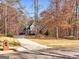 Charming brick home with a well-maintained lawn surrounded by colorful fall foliage and mature trees at 340 Antebellum Way, Fayetteville, GA 30215