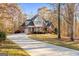 Charming brick home with a well-maintained lawn surrounded by colorful fall foliage and mature trees at 340 Antebellum Way, Fayetteville, GA 30215