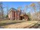 Large brick house featuring a wooden deck and patio at 340 Antebellum Way, Fayetteville, GA 30215