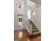 Bright foyer with hardwood floors, staircase, transom window, and a beautifully decorated front door at 340 Antebellum Way, Fayetteville, GA 30215