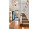 Elegant foyer features hardwood floors, a grand staircase, chandelier, and a beautifully decorated front door at 340 Antebellum Way, Fayetteville, GA 30215