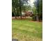 Beautiful front yard with mature trees surrounding a two-story brick home at 340 Antebellum Way, Fayetteville, GA 30215