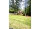 Spacious front yard with mature trees framing a stately two-story brick home at 340 Antebellum Way, Fayetteville, GA 30215