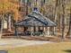 A beautiful gazebo with a gray roof and picnic tables surrounded by lush trees at 340 Antebellum Way, Fayetteville, GA 30215