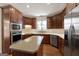 Gourmet kitchen features stainless steel appliances, large island, and custom cabinetry at 340 Antebellum Way, Fayetteville, GA 30215